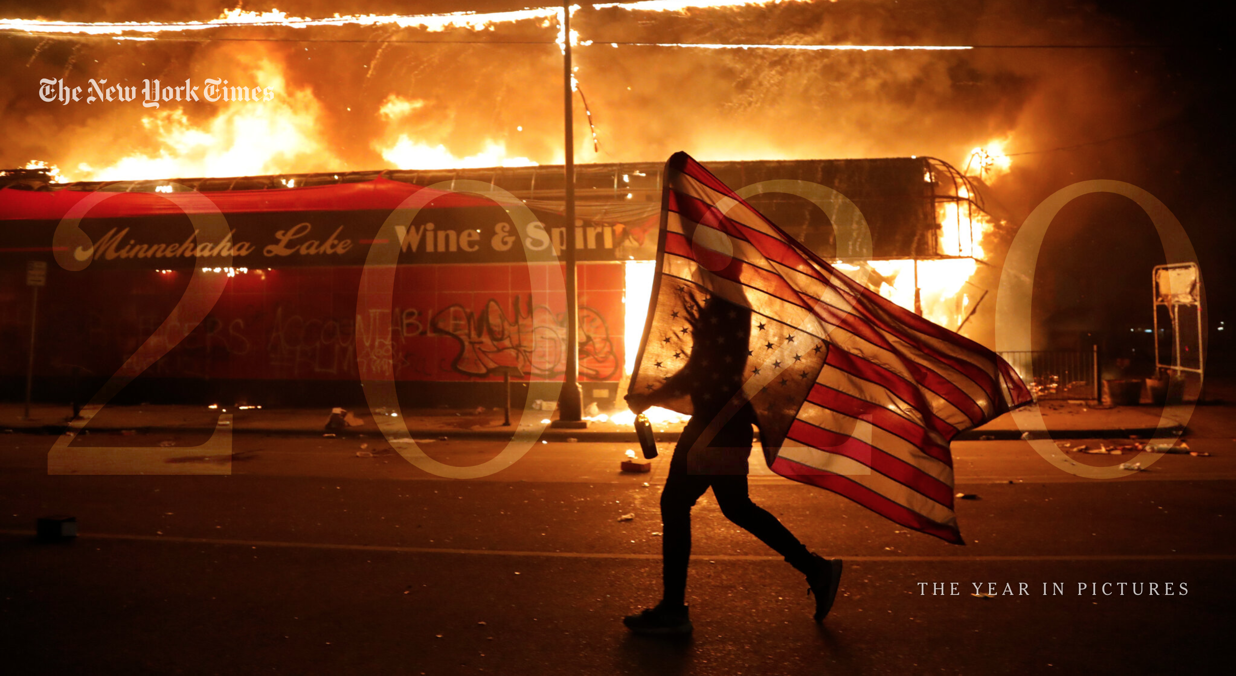 Screenshot of the New York Times 2020 Year in Pictures, showing a person holding an upside-down American flag against the backdrop of a burning building.